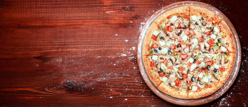 fresh american pizza on wooden table with space for text