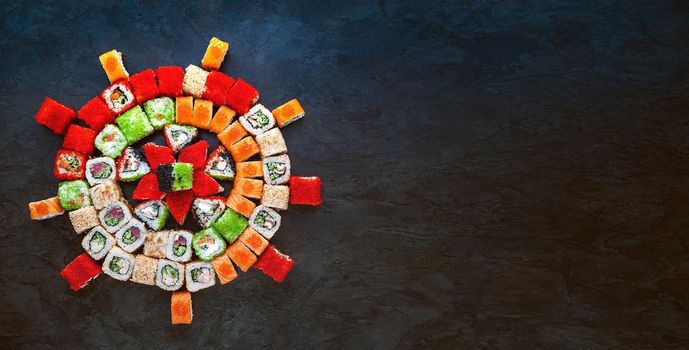 Sushi net on a black surface. Flat lay.