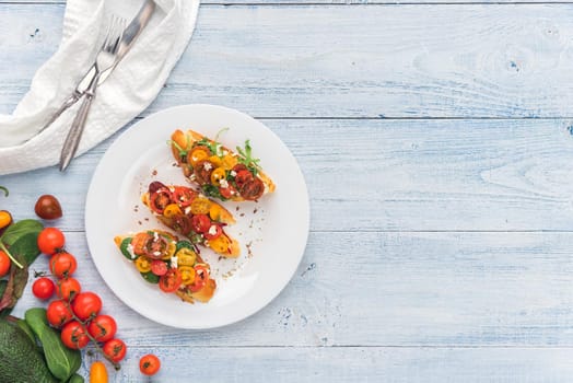 Bruschetta with cheese, basil, arugula and cherry tomatoes