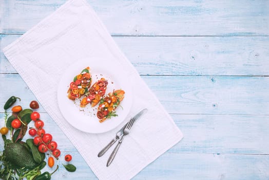 Bruschetta with cheese, basil, arugula and cherry tomatoes