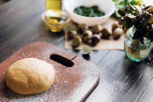 Step by step the chef prepares ravioli with ricotta cheese, yolks quail eggs and spinach with spices. A set of products for ravioli