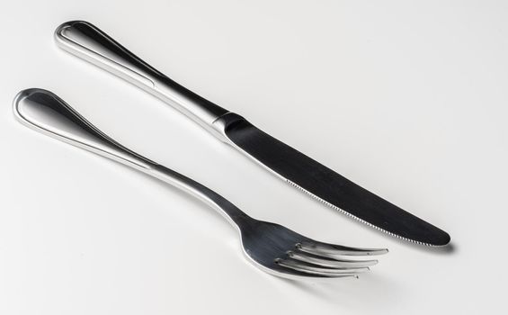 Fork and knife isolated on white background. Close up.