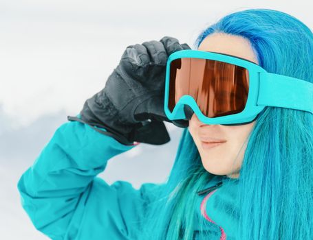 Sporty young woman in sunglasses in winter outdoor.