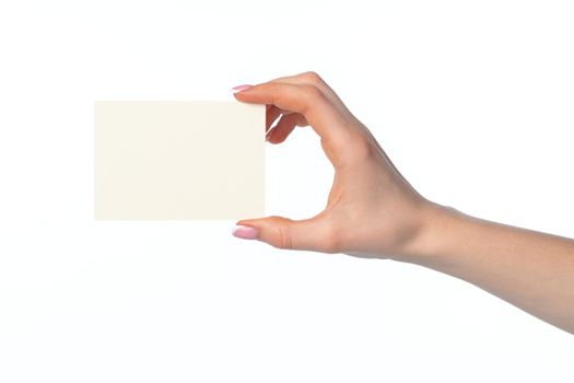 Woman's hand with blank white business card isolated on white background