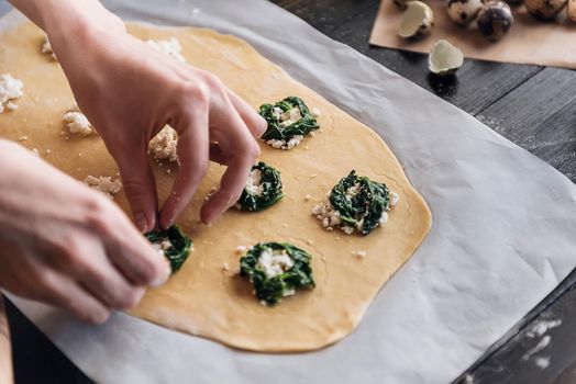 Step by step the chef prepares ravioli with ricotta cheese, yolks quail eggs and spinach with spices. The chef prepares the filling on the dough