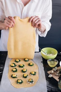 Step by step the chef prepares ravioli with ricotta cheese, yolks quail eggs and spinach with spices. The chef creates ravioli