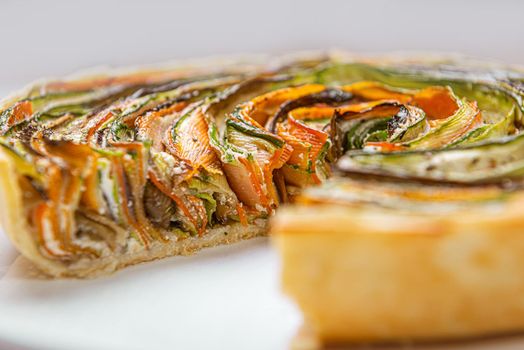 classic ratatouille pie on a light gray table.