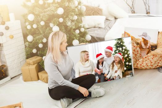 woman holding a photo canvas on the background of a Christmas interior.