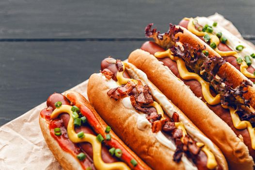 Barbecue Grilled Hot Dogs with  yellow American mustard, On a dark wooden background