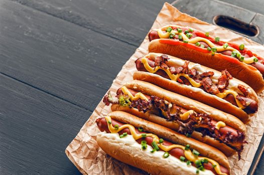 Barbecue Grilled Hot Dogs with  yellow American mustard, On a dark wooden background