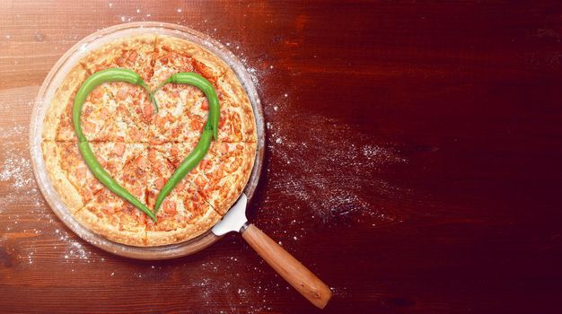 Valentine's Day pizza with peppers laid on top of a pizza