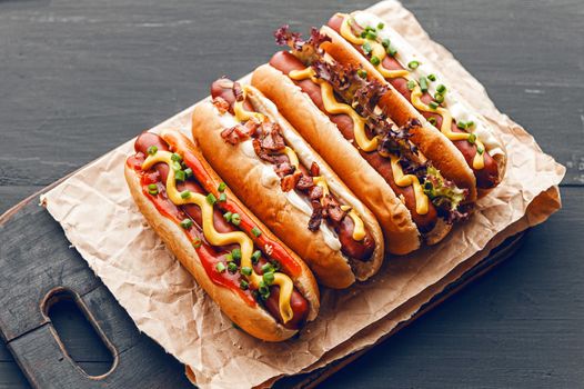 Barbecue Grilled Hot Dogs with  yellow American mustard, On a dark wooden background