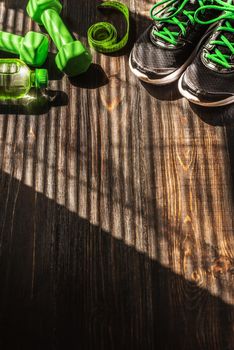 Sneakers dumbbells and a bottle of water. Flat view. All in one color.