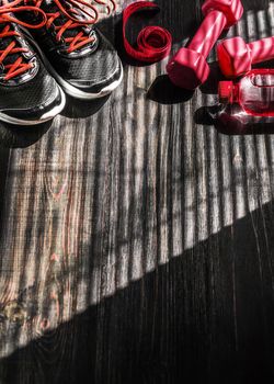 Sneakers dumbbells and a bottle of water. Flat view. All in one color.