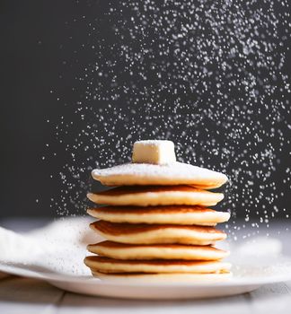 fresh classic pancake stacked in stack on gray background with place for text
