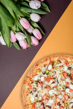 fresh pizza and spring flowers tulips. with space for text