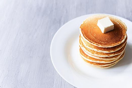 fresh classic pancake stacked in stack on gray background with place for text