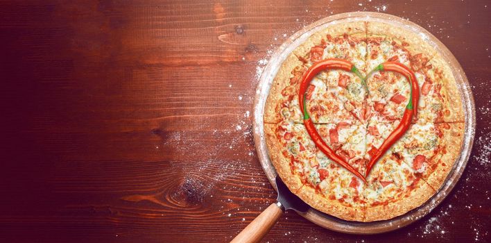 Valentine's Day pizza with peppers laid on top of a pizza