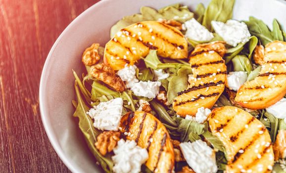 Salad of peaches grilled, ricotta and arugula. Healthy food