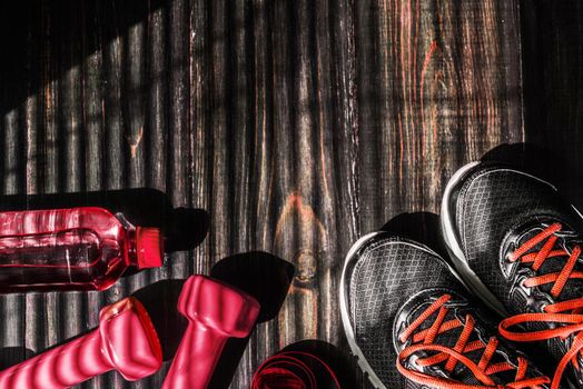 Sneakers dumbbells and a bottle of water. Flat view. All in one color.