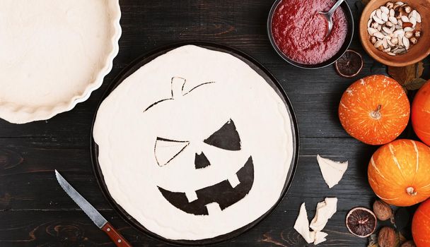 Chef cooks a pie for Halloween with a filling of pumpkin-strawberry jam and peaches