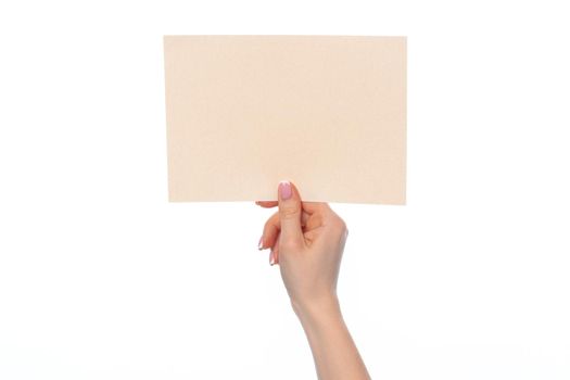 Craft paper card in female hand isolated on white background