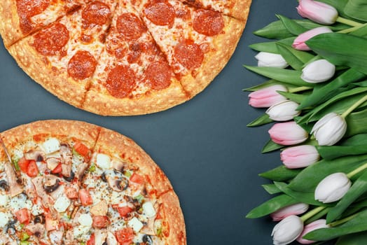 fresh pizza and spring flowers tulips. with space for text