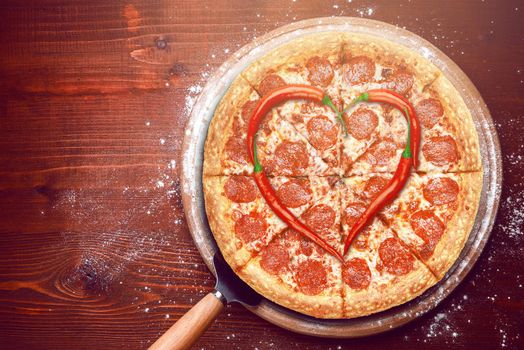 Valentine's Day pizza with peppers laid on top of a pizza