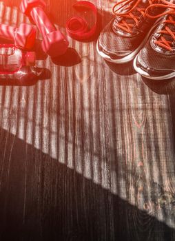 Sneakers dumbbells and a bottle of water. Flat view. All in one color.