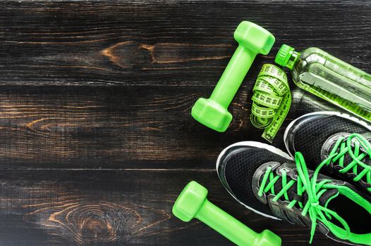 Sneakers dumbbells and a bottle of water. Flat view. All in one color.