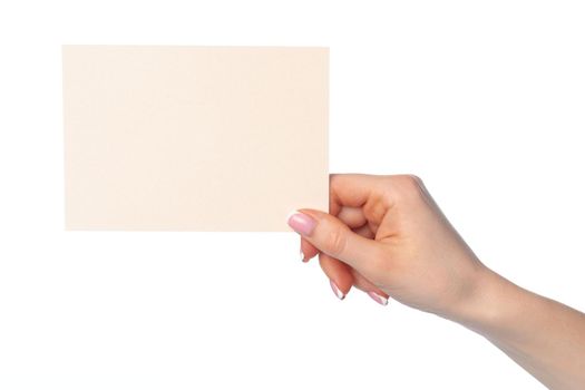 Female hand holding blank white sheet of paper isolated on white background