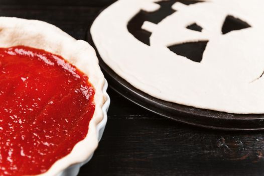 Chef cooks a pie for Halloween with a filling of pumpkin-strawberry jam and peaches