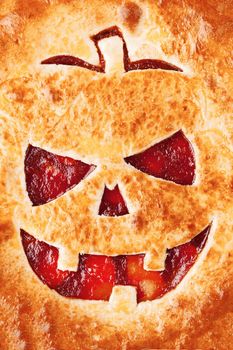 Delicious homemade pie for halloween with a filling of pumpkin-strawberry jam and peaches