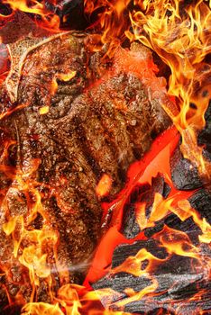 grilled marbled beef steak with coals and smoke