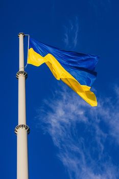National yellow-blue flag of Ukraine waving on the blue sky background.