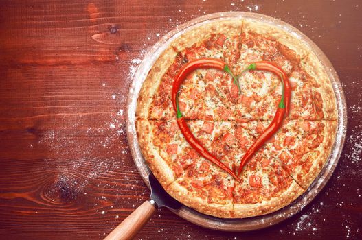 Valentine's Day pizza with peppers laid on top of a pizza