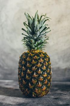 Fresh isolated pineapple on grey background.