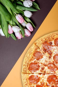 fresh pizza and spring flowers tulips. with space for text