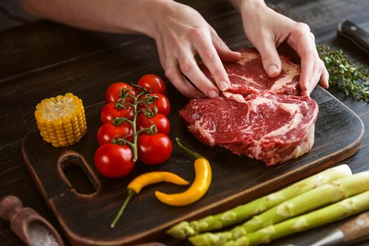 set for cooking a festive dinner for two. two raw marbled beef steaks, spices, vegetables 