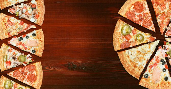 mix of eight different pizzas on a wooden background. menu concept of choice and diversity