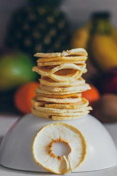 Dried homemade healthy fresh dehydrated slices of fruits. Fruit chips, natural raw vegan organic snack. Healthy food concept.