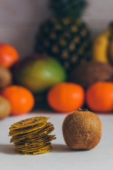 Dried homemade healthy fresh dehydrated slices of fruits. Fruit chips, natural raw vegan organic snack. Healthy food concept.