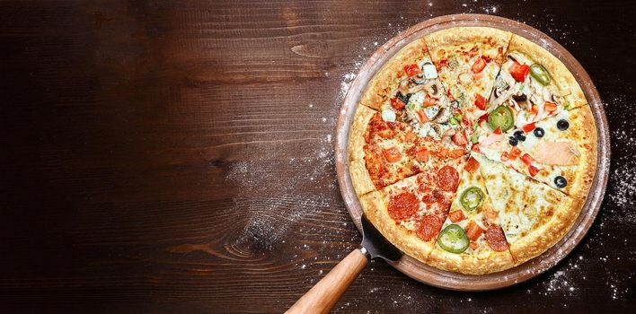 mix of eight different pizzas on a wooden background. menu concept of choice and diversity