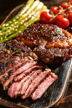 Dinner for two juicy delicious steaks, asparagus with parmesan and vegetables.