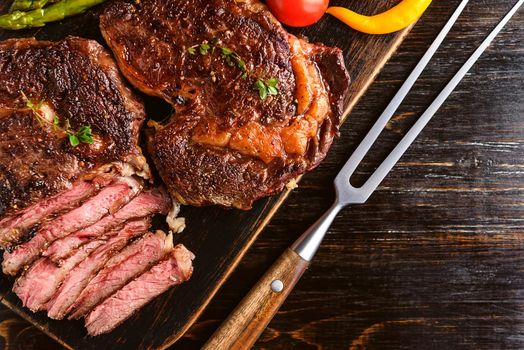 Dinner for two juicy delicious steaks, asparagus with parmesan and vegetables.