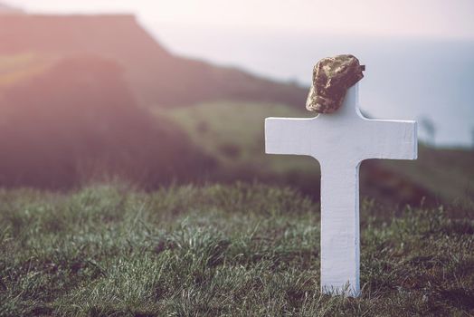 military cap on the grave cross