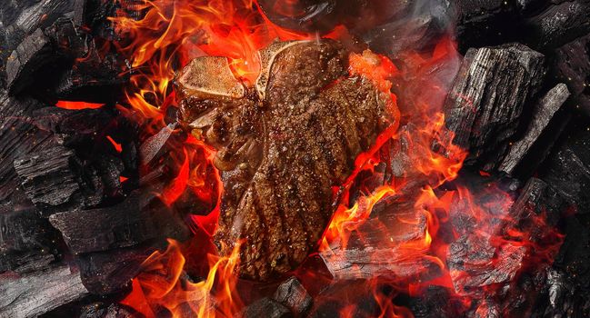 grilled marbled beef steak with coals and smoke