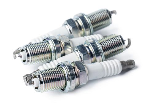 Car part. Spark plugs isolated on white. Close up.