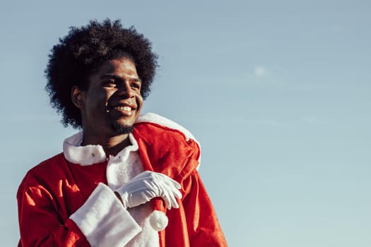 African american santa claus over sky background