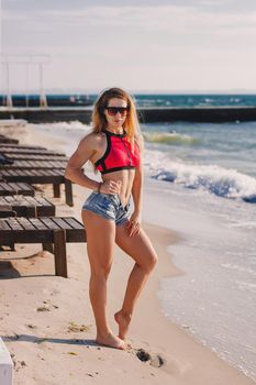 Young healthy lifestyle sport fitness instructor happy woman in bikini on beach